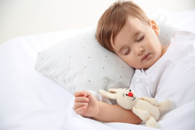 Cute little baby sleeping with toy at home. Bedtime