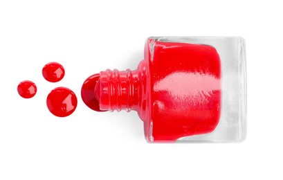 Photo of Bottle and red nail polish drops isolated on white, top view