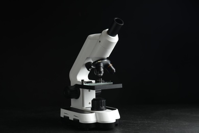 Modern microscope on black background. Medical equipment