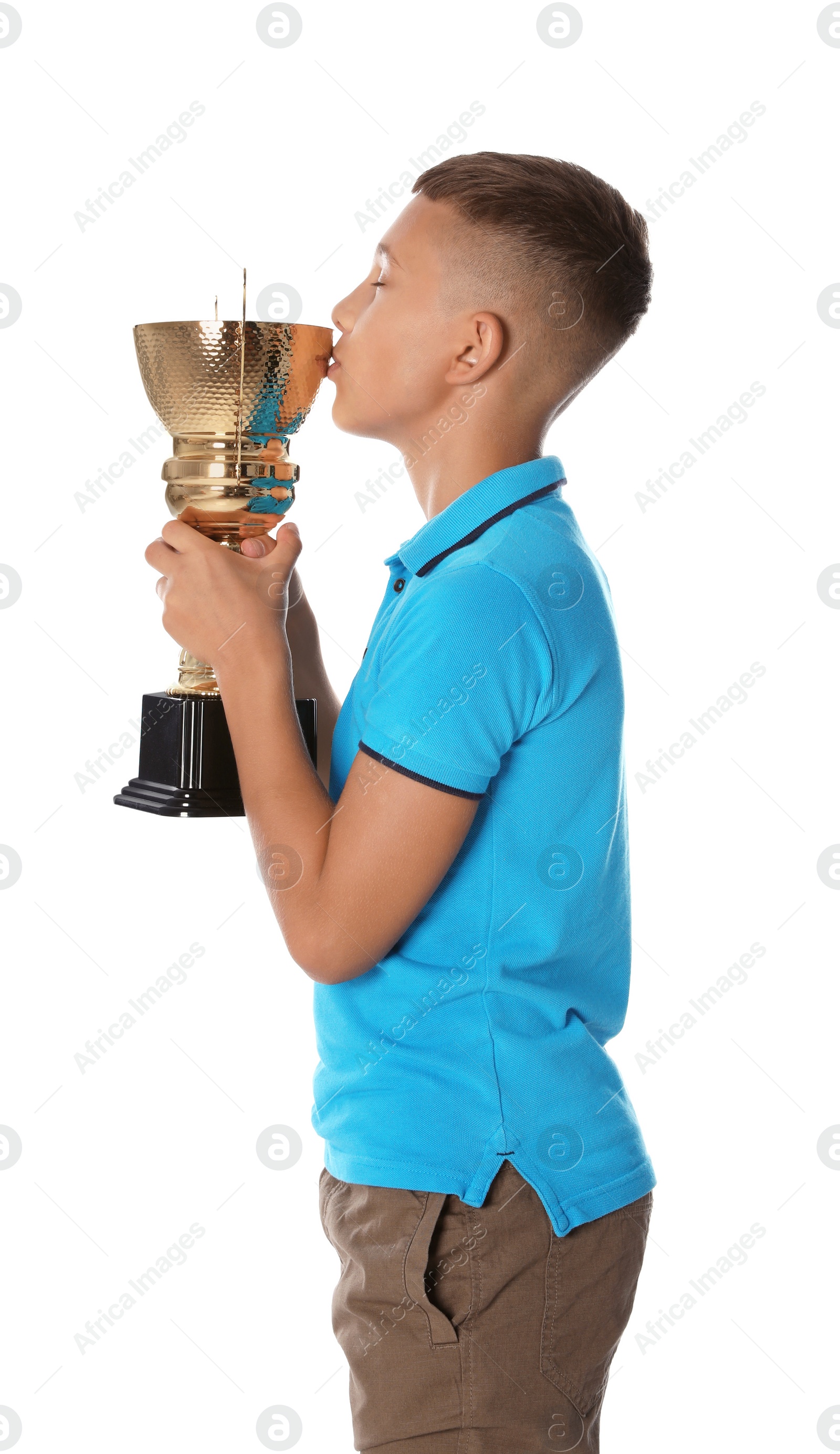 Photo of Happy boy kissing golden winning cup on white background