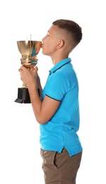 Photo of Happy boy kissing golden winning cup on white background