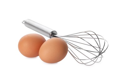 Photo of Metal whisk and raw eggs isolated on white