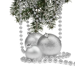 Photo of Silver Christmas balls, fir branches and beads isolated on white