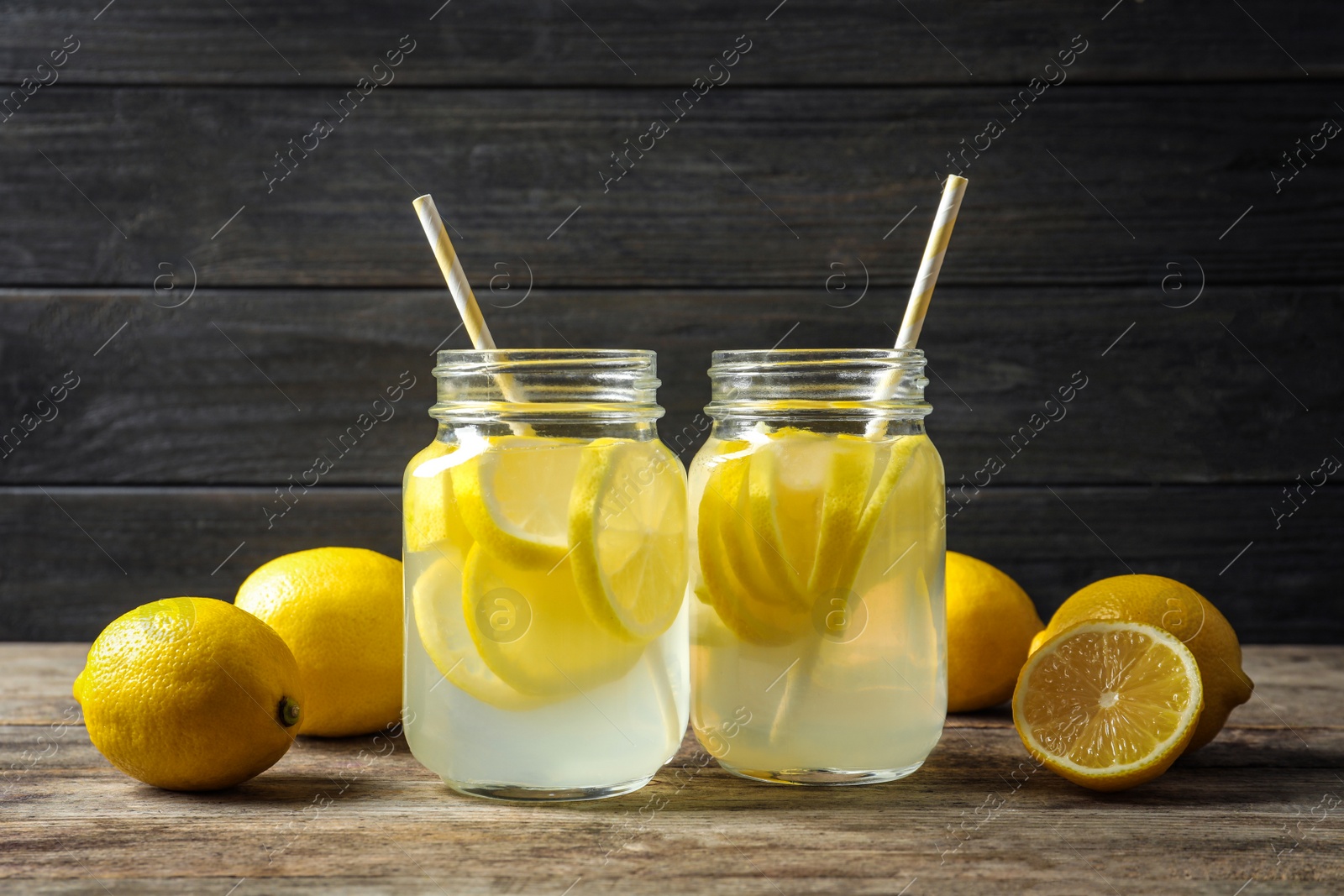 Photo of Natural lemonade in mason jars on wooden table