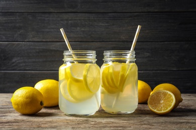 Photo of Natural lemonade in mason jars on wooden table