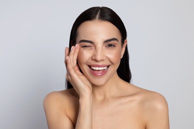 Photo of Portrait of attractive young woman on light grey background. Spa treatment