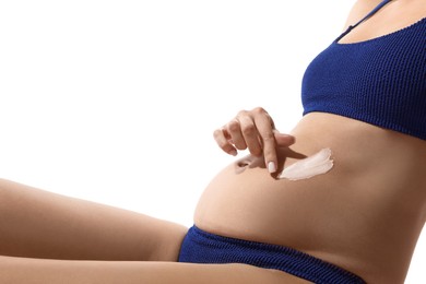 Photo of Pregnant woman applying sun protection cream on her belly against white background, closeup