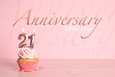 Image of Delicious cupcake with number shaped candles on pink background. Coming of age party - 21th birthday. Anniversary celebration