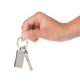 Woman holding key with metallic keychain on white background, closeup