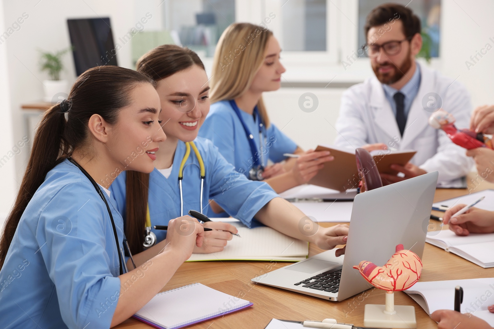 Photo of Medical students in uniforms studying at university