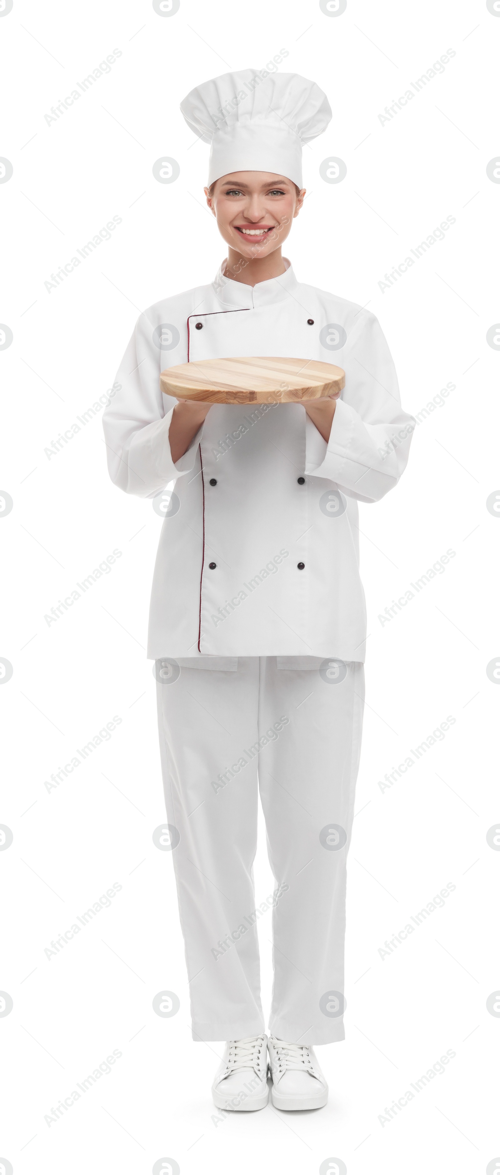 Photo of Happy chef in uniform holding empty wooden board on white background