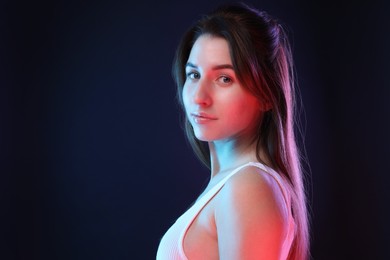Photo of Portrait of beautiful young woman on color background, space for text