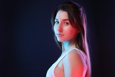 Portrait of beautiful young woman on color background, space for text