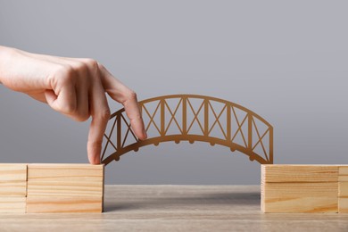 Image of Woman walking over drawn bridge with her fingers, closeup