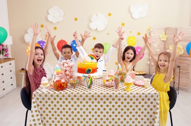 Cute children celebrating birthday at table indoors
