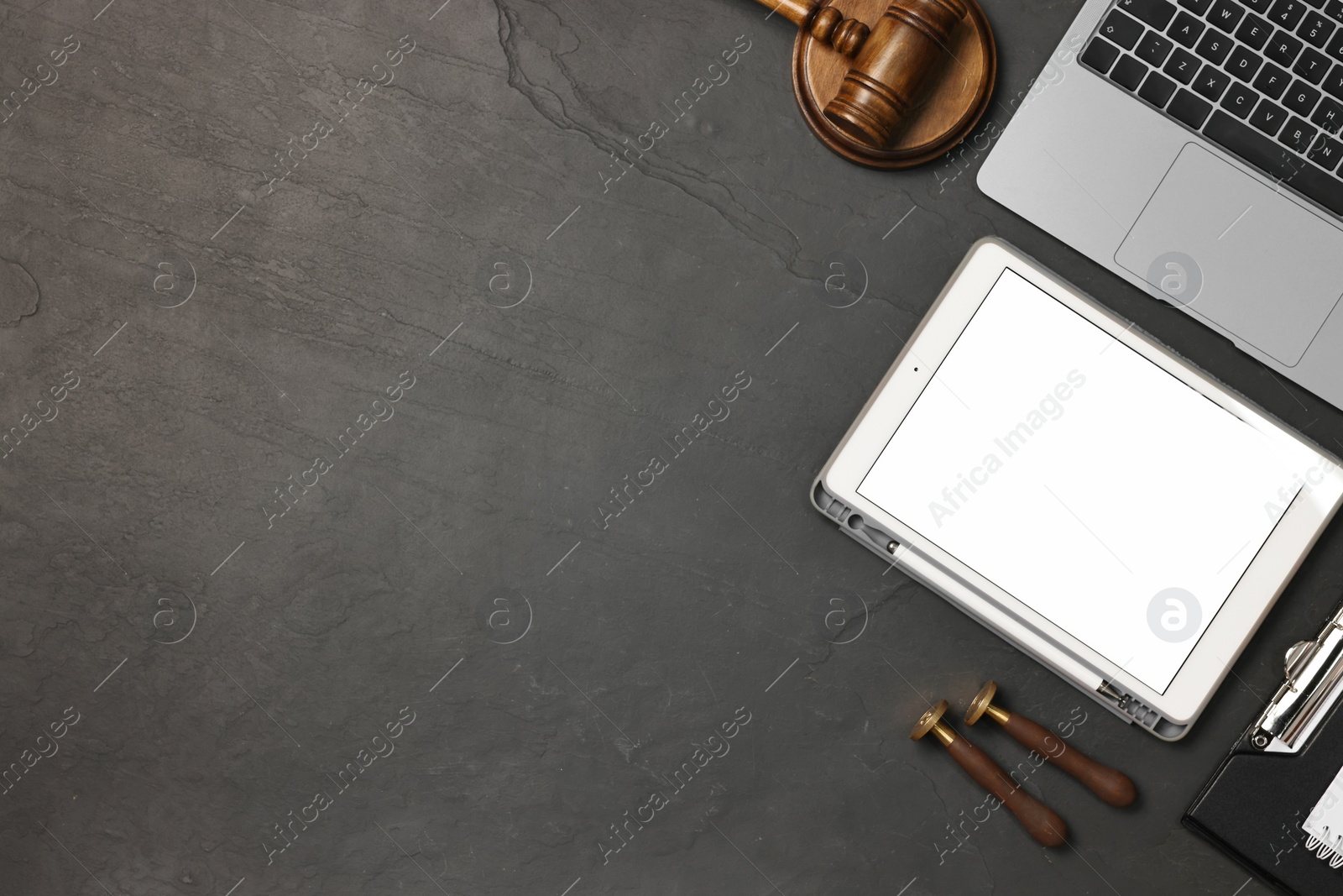 Photo of Flat lay composition with modern tablet on dark gray textured table. Space for text