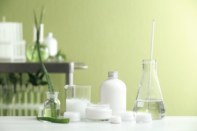 Photo of Composition with herbal cosmetic products and ingredients in laboratory