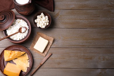 Photo of Flat lay composition with dairy products and clay dishware on grey wooden table. Space for text