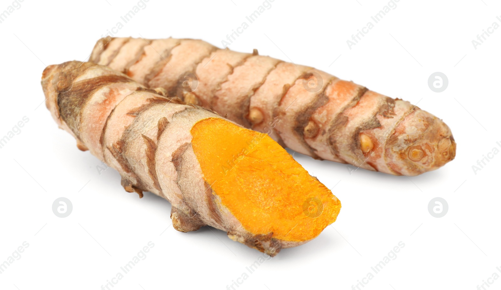 Photo of Fresh whole and cut turmeric roots isolated on white