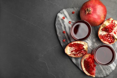 Photo of Pomegranate juice and fresh fruits on dark table, top view. Space for text