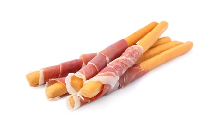 Photo of Delicious grissini sticks with prosciutto on white background