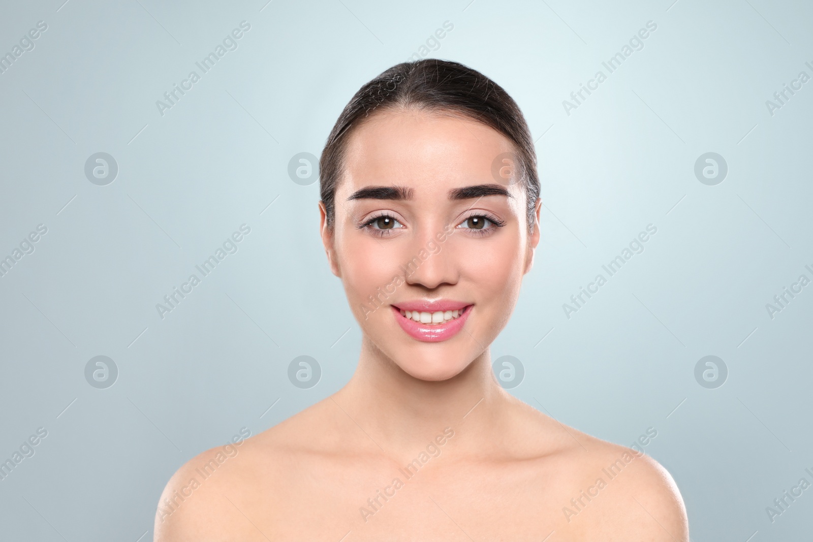 Photo of Portrait of young woman with beautiful face against color background