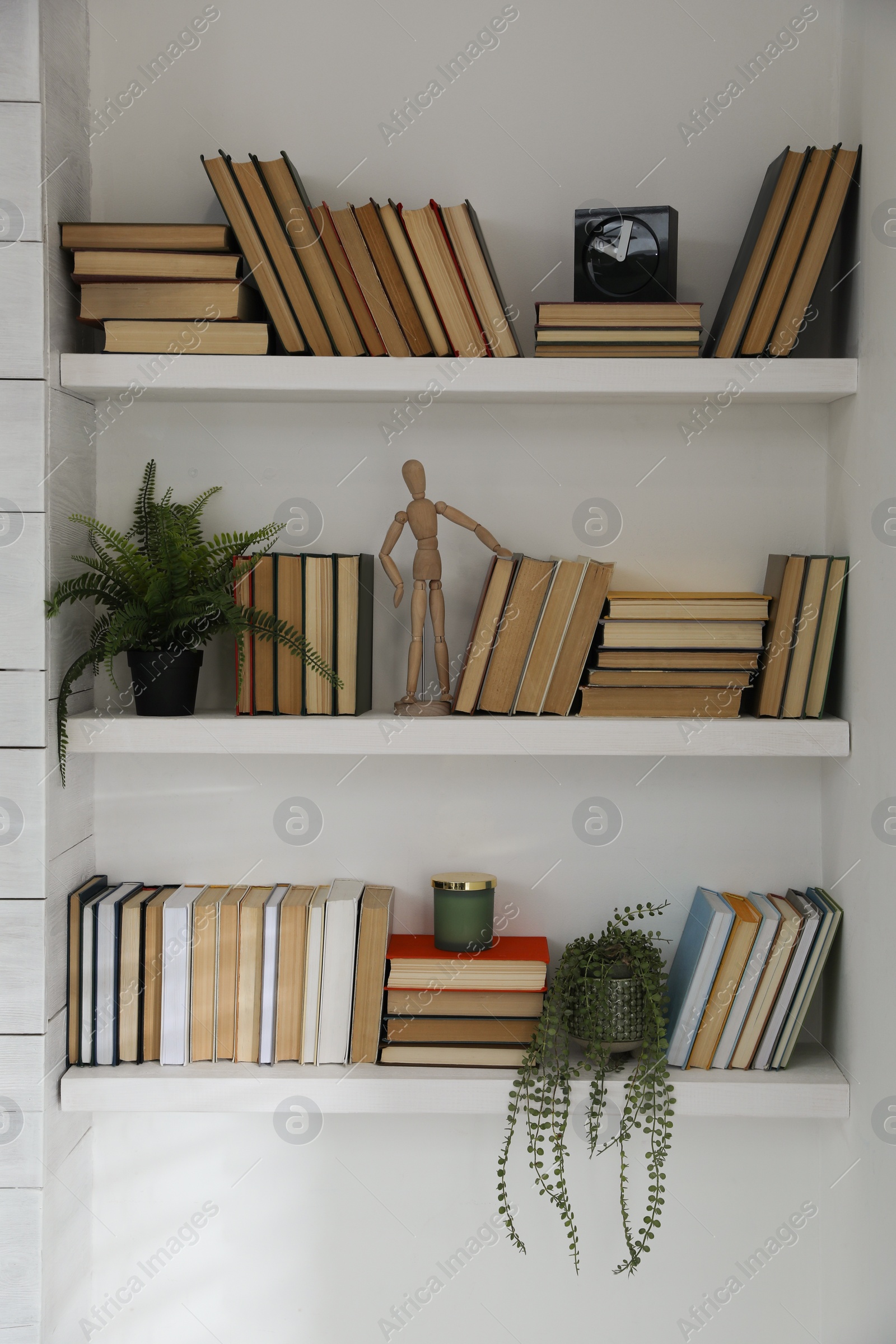 Photo of Many shelves with different decor in room. Interior design