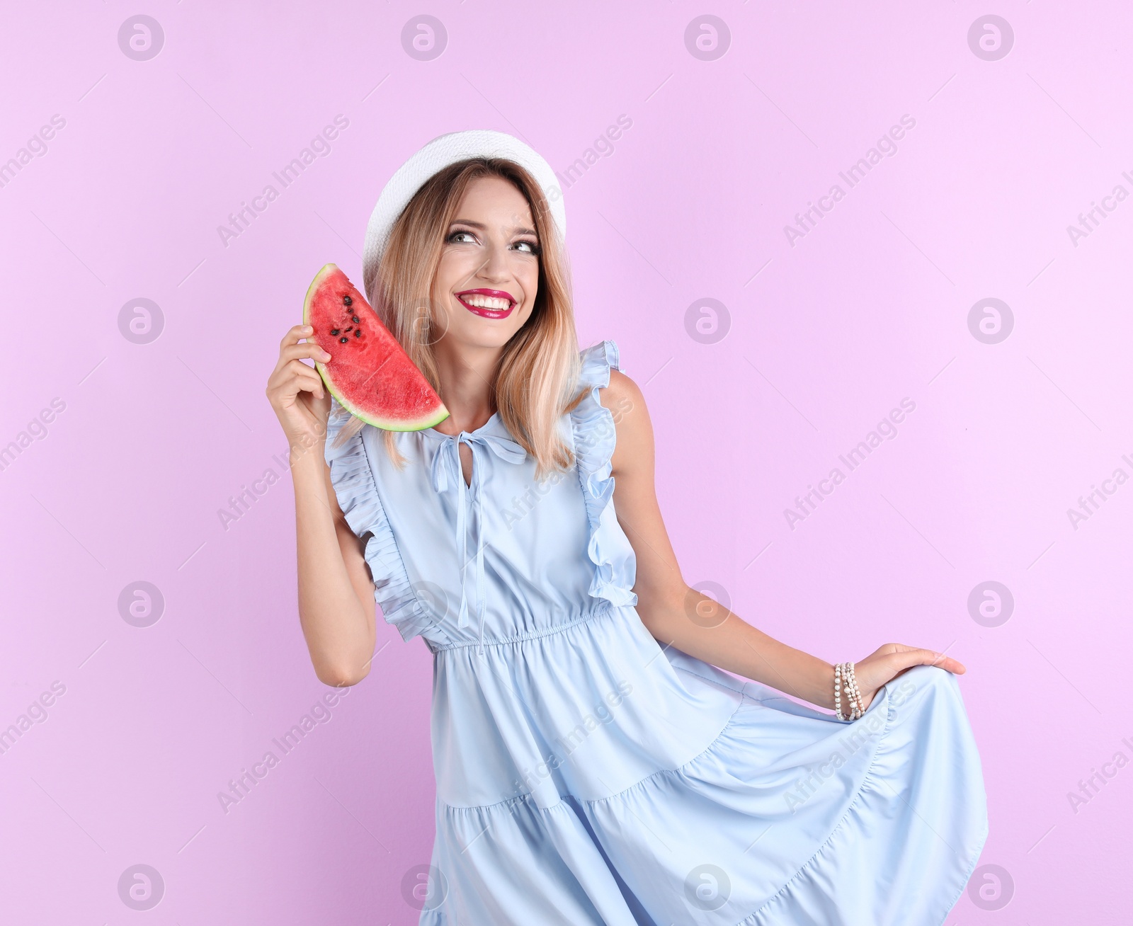 Photo of Pretty young woman with juicy watermelon on color background