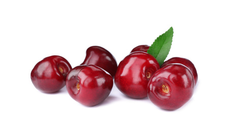 Photo of Tasty ripe red cherries with green leaf isolated on white