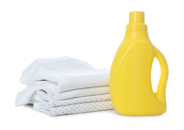 Photo of Detergent and children's clothes on white background