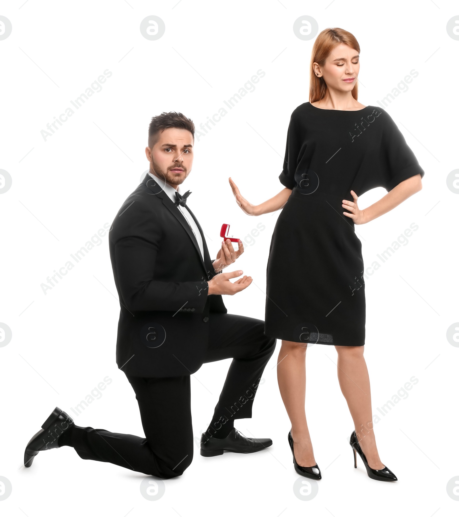 Photo of Young woman rejecting engagement ring from boyfriend on white background