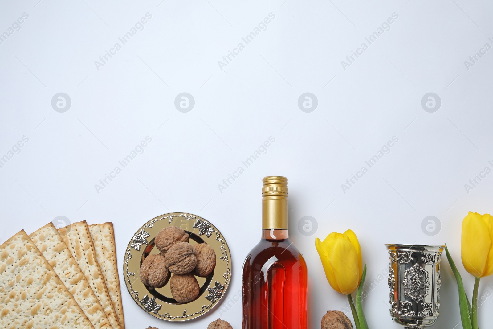 Photo of Composition with symbolic Passover (Pesach) items on white background, top view. Space for text