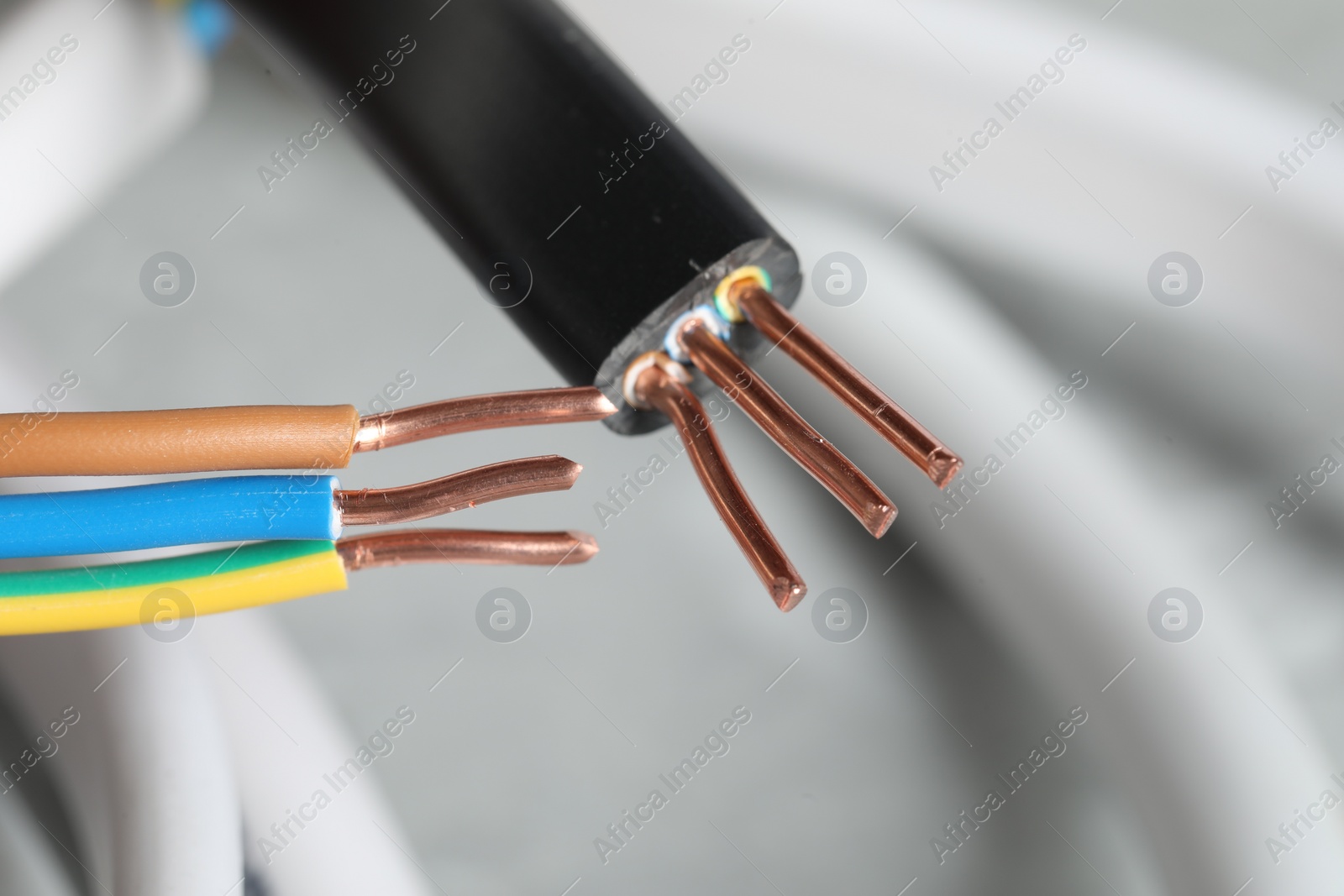 Photo of Colorful electrical wires on blurred background, closeup