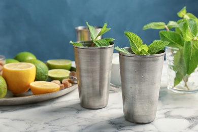 Photo of Composition with delicious mint julep cocktail on table