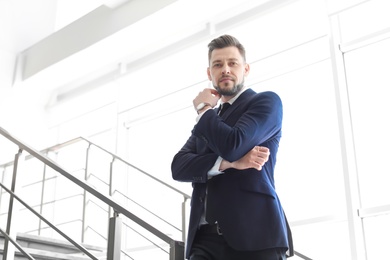 Photo of Male lawyer standing near stairs in office