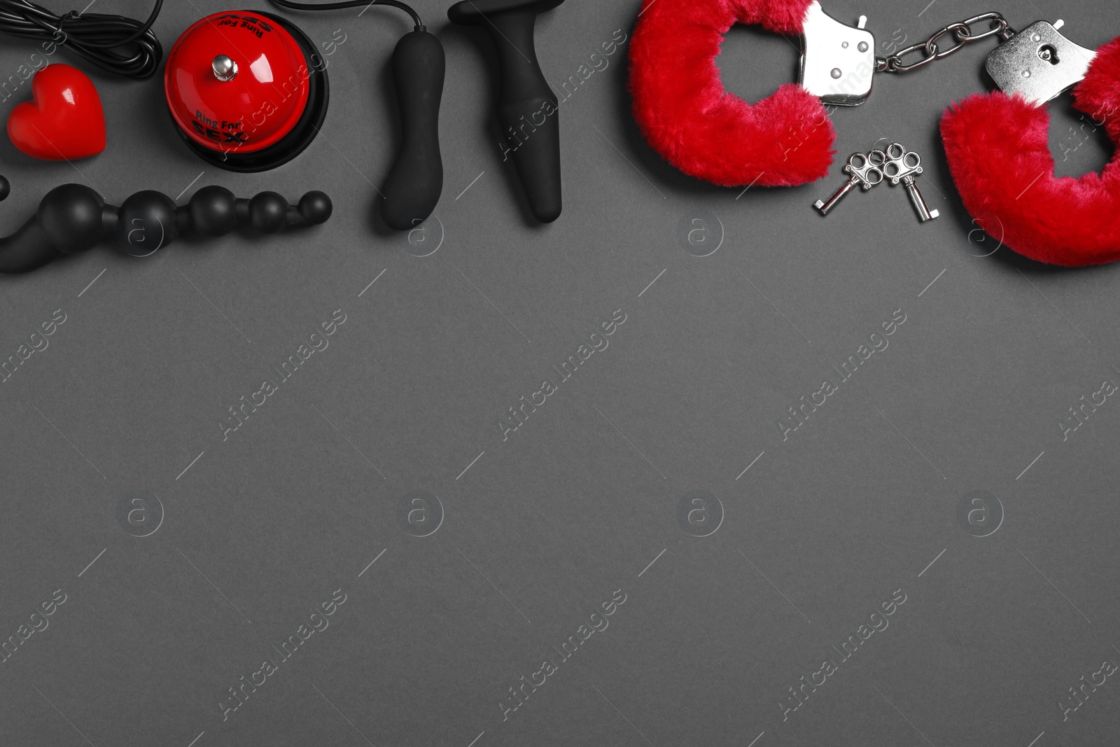 Photo of Different sex toys on dark background, flat lay. Space for text