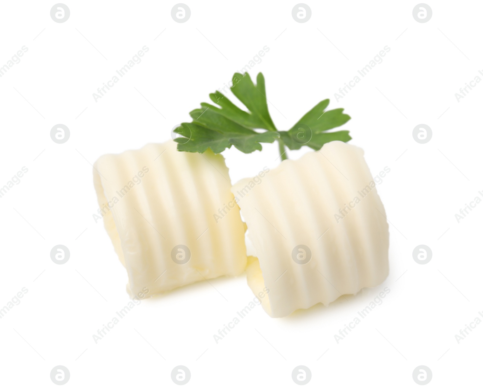 Photo of Tasty butter curls and fresh parsley isolated on white, top view