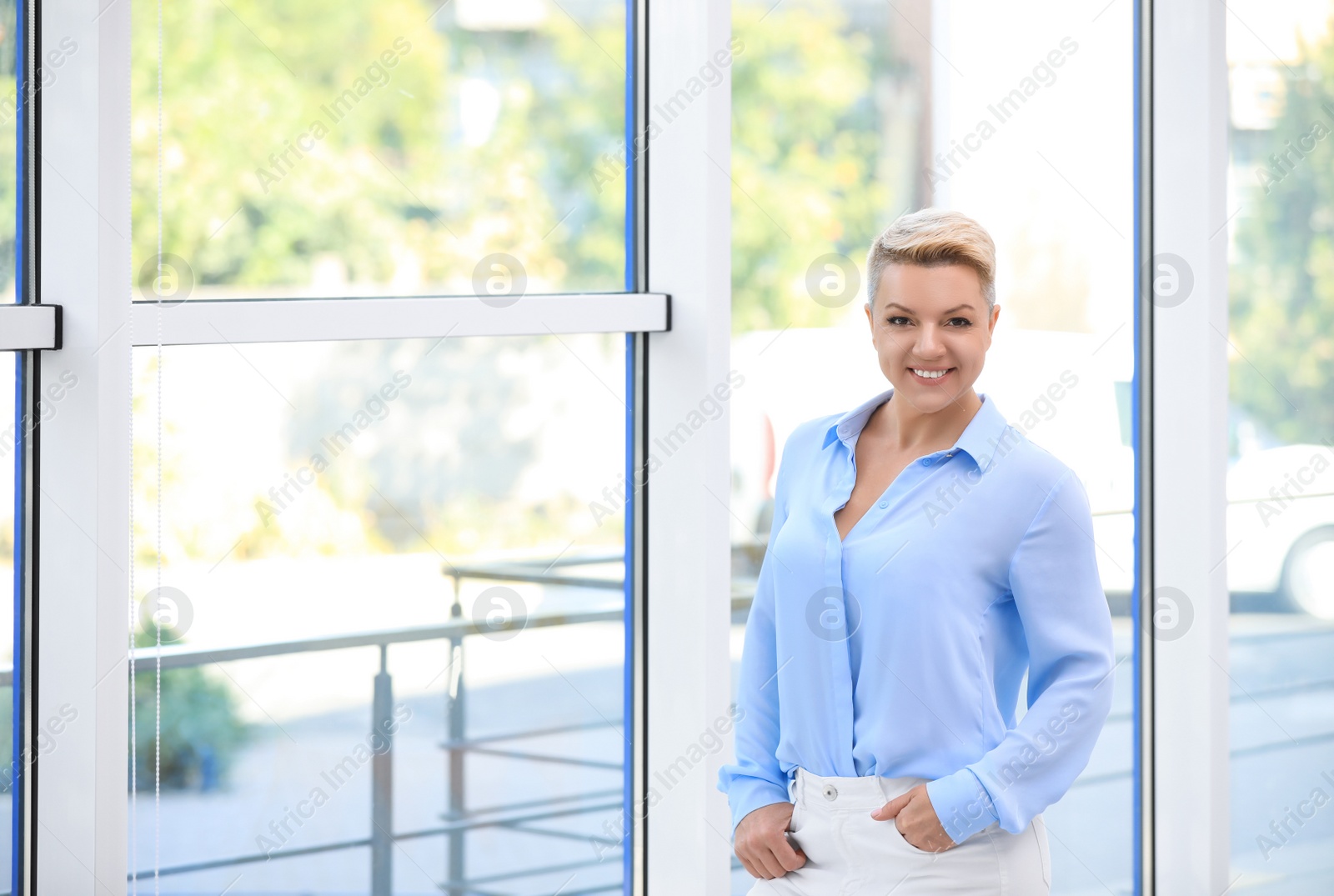 Photo of Portrait of attractive business woman near window at office