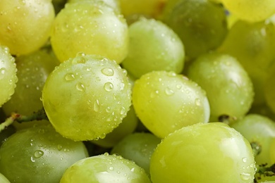 Fresh ripe juicy white grapes as background, closeup view