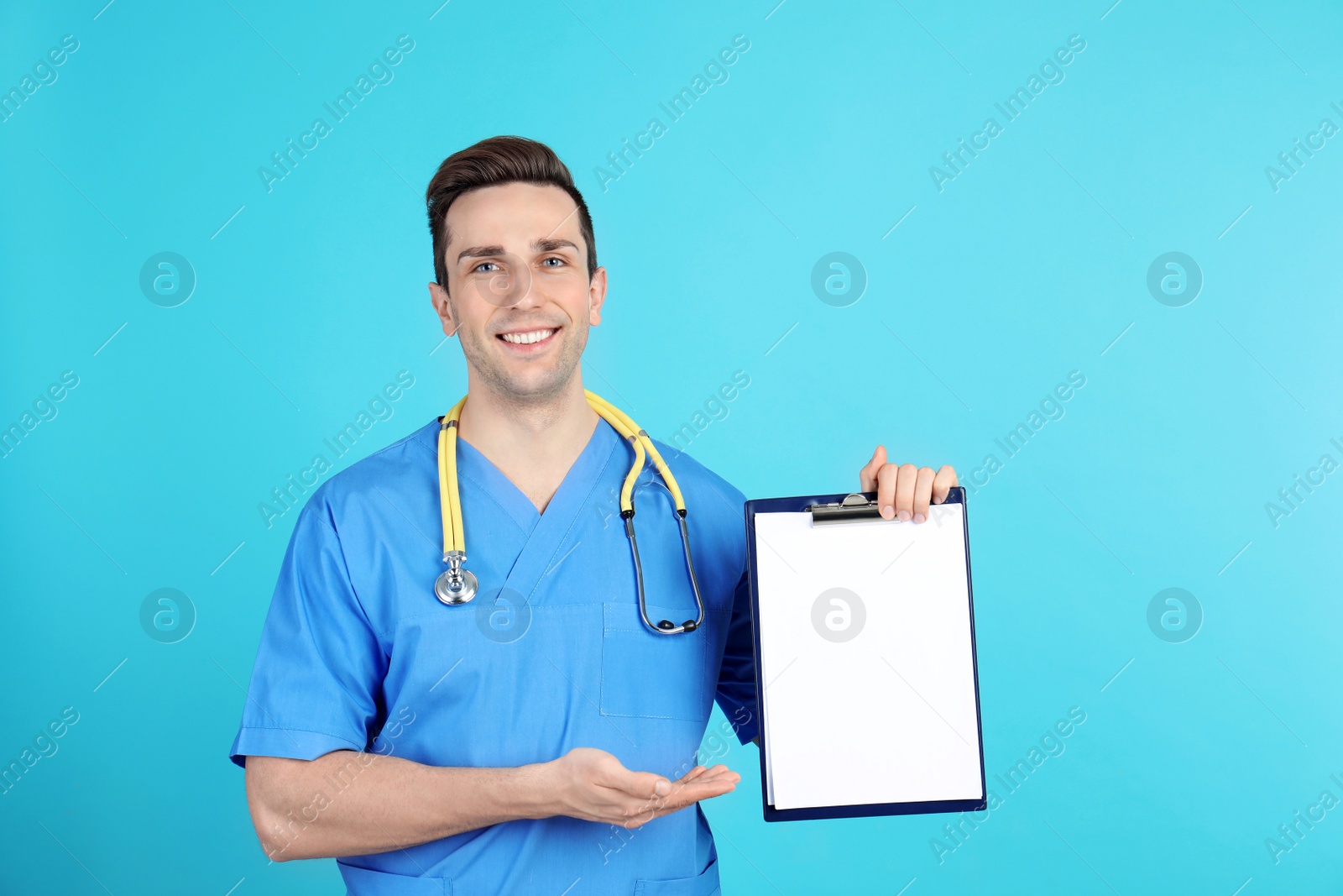 Photo of Portrait of medical assistant with stethoscope and clipboard on color background. Space for text