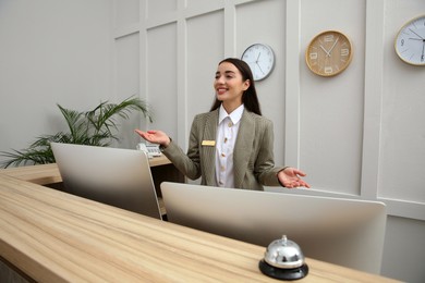 Beautiful receptionist working at counter in hotel
