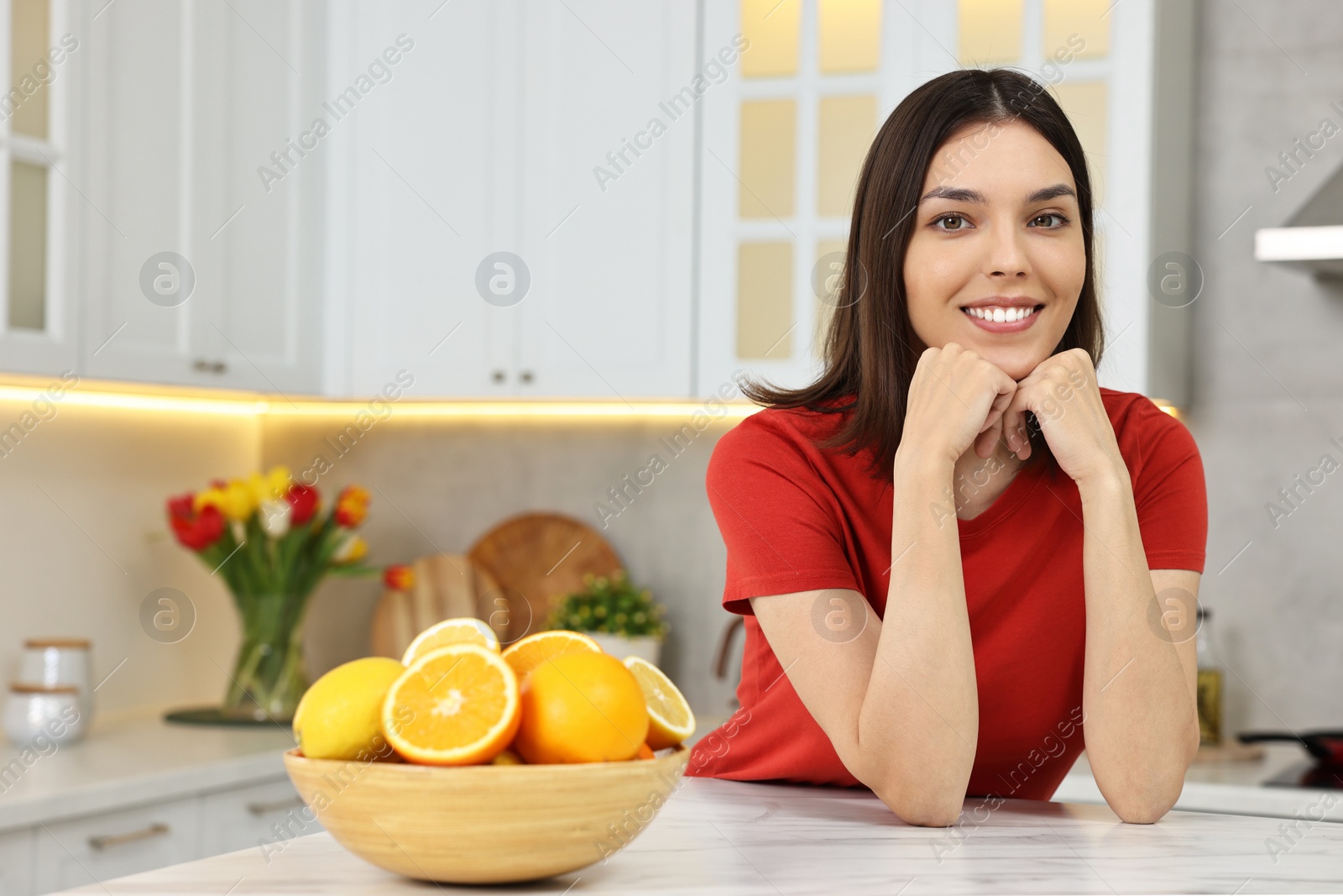 Photo of Portrait of beautiful young woman in kitchen