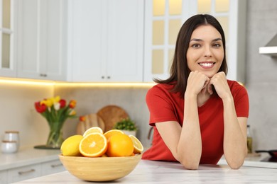 Portrait of beautiful young woman in kitchen