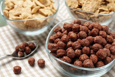 Photo of Different delicious breakfast cereals on kitchen towel, closeup