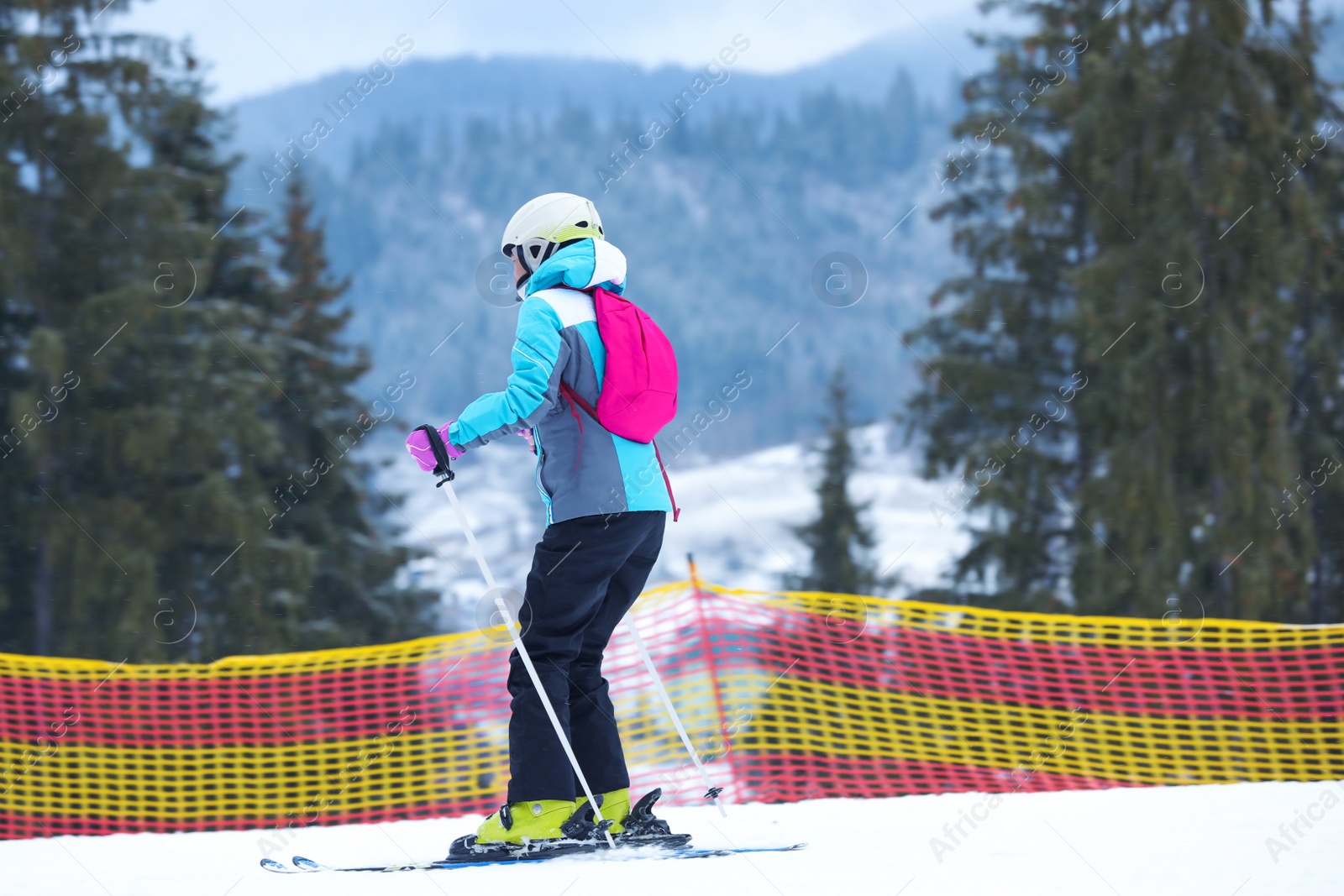 Photo of Skier on slope at resort. Winter vacation