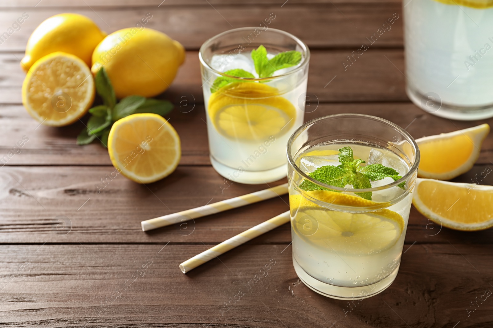 Photo of Glasses with natural lemonade on wooden table