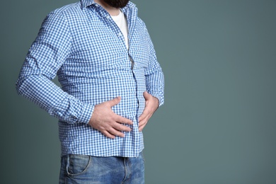 Overweight man on color background