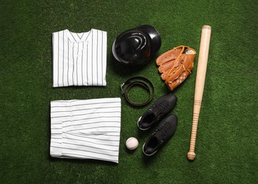 Photo of Flat lay composition with baseball equipment on artificial grass. Space for text