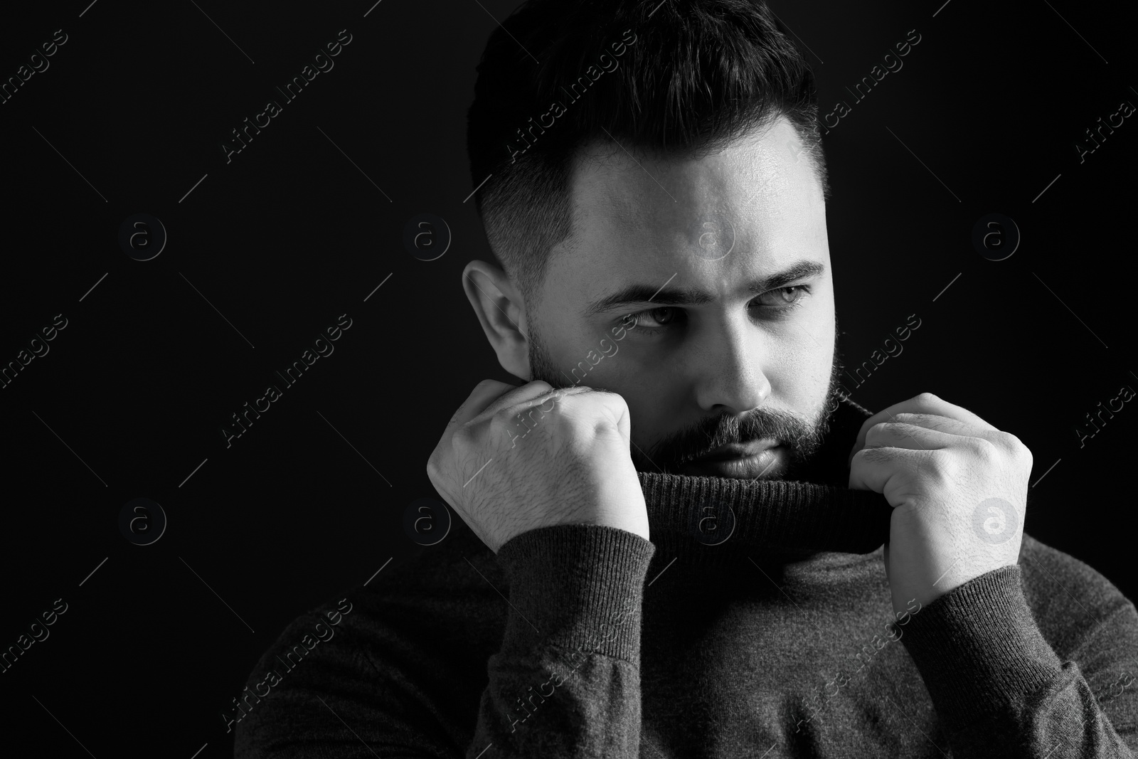 Photo of Portrait of handsome bearded man on dark background, space for text. Black and white effect