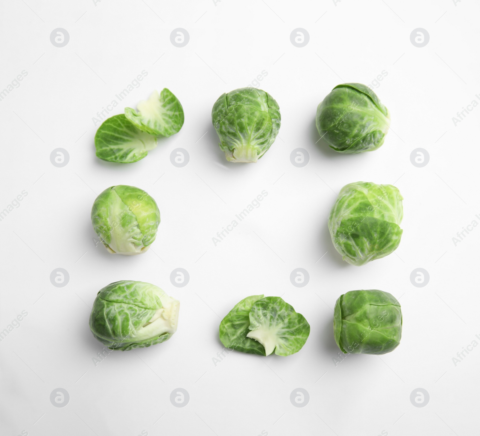 Photo of Fresh Brussels sprouts on white background, top view. Space for text